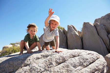 Boys playing on rock, Kubu Island, Makgadikgadi Pan, Botswana, Africaの写真素材