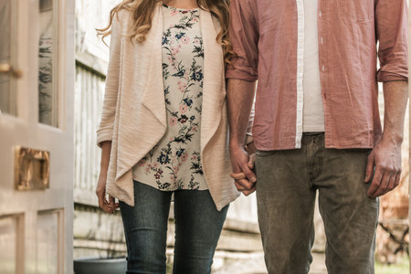 Couple standing outside an open doorの写真素材