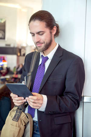 Businessman on business trip using digital tablet, New York, USAの写真素材