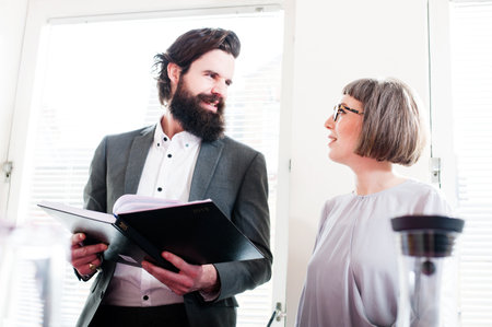 Colleagues in office, man holding bookの写真素材
