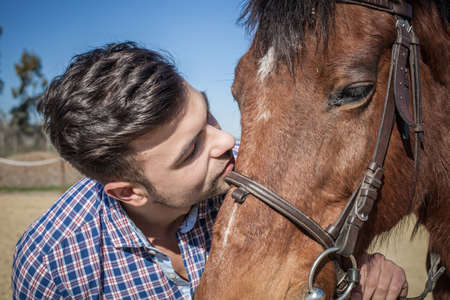 Young man with horseの写真素材
