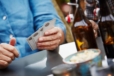 Person holding playing cards, close upの写真素材