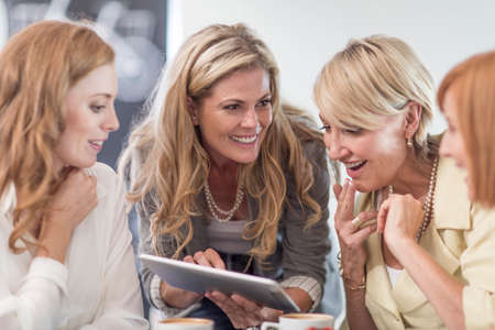 Business woman using digital tablet at business lunchの写真素材