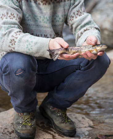 Man holding freshly caught fishの写真素材