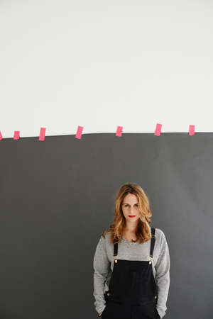 Mid adult woman standing with hands in pockets