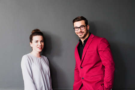Two people by grey wall