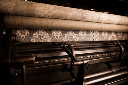 Intricate lace on old weaving machine in textile mill
