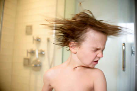 Boy shaking wet hairの写真素材