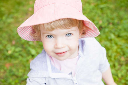 Portrait of female toddler wearing pink sunhatの写真素材