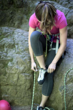 Rock climber tying shoelace, French's Dome, Zig Zag, Oregon, USAの写真素材