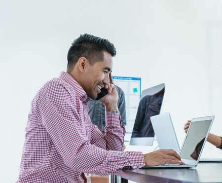 Businessman working on laptop in office