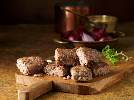 Venison with red onion and thyme stuffing on rustic chopping boardの写真素材