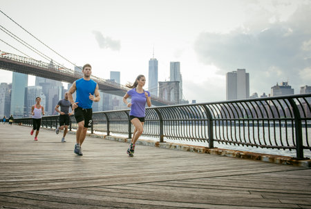 Group of people running in front of Brooklyn bridge, New York, USAの写真素材