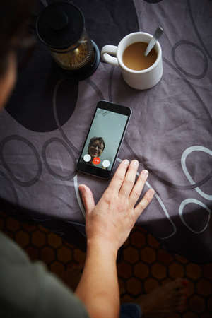 Woman using smartphone to make video call