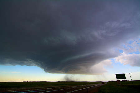 Rotating supercell storm over highway, with streaks indicating falling hail, southeast of Scottsbluff, Nebraska, USAの写真素材