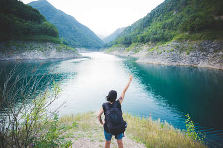 Tourist raising arm at Lake Garda, Italyの写真素材