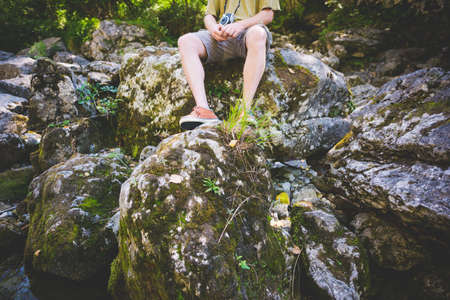 Tourist sitting on rocks, Garda, Italyの写真素材