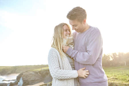 Happy romantic young couple on date at beach