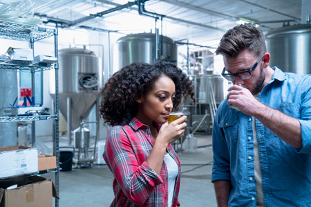 Colleagues in brewery sampling beer