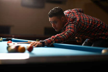 Man playing pool in clubの写真素材