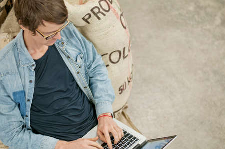 Man using laptop on floor