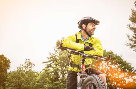 Low angle view of mature male mountain biker taking a break