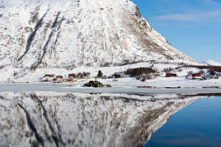 Snow covered mountain reflected in water, Knutstad, Lofoten Islands, Norwayの写真素材