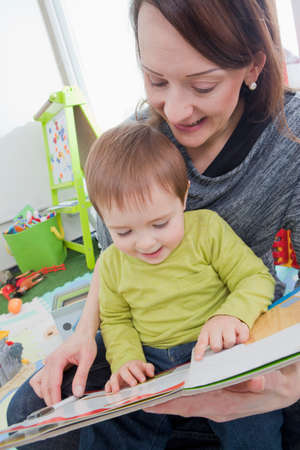 Mother reading to son at home