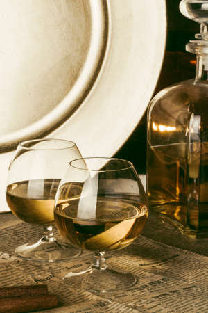 Two glasses of brandy, decanter