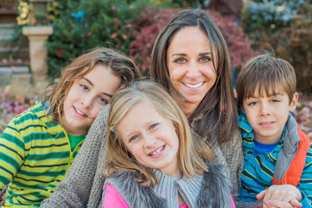Mother and children smiling in gardenの写真素材