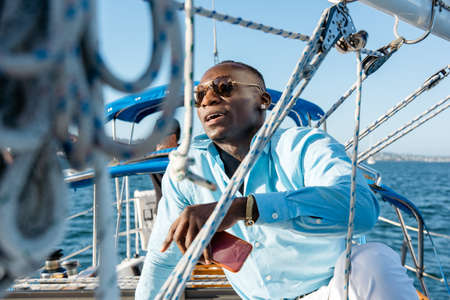 Man relaxing on sailboatの写真素材