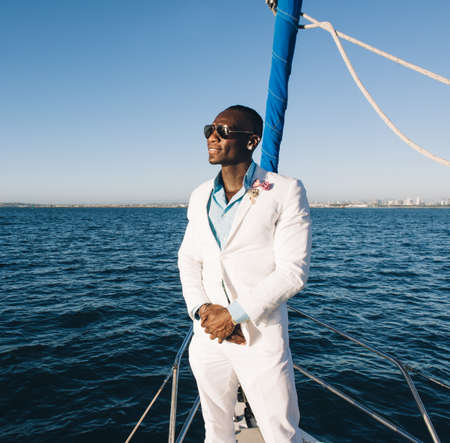 Man enjoying view on sailboat, San Diego Bay, California, USAの写真素材