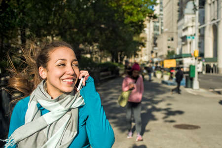 Young woman using smartphone in parkの写真素材