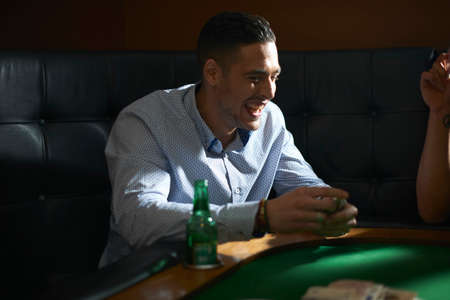 Man shuffling playing cards at pub card tableの写真素材