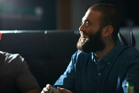 Man shuffling playing cards in traditional UK pubの写真素材
