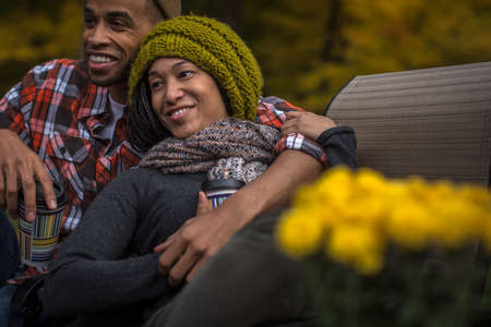 Romantic mid adult couple at dusk in autumn gardenの写真素材