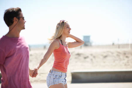 Couple outdoors, holding handsの写真素材