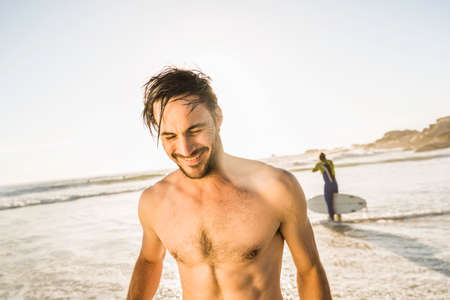 Bare chested mid adult man on beach, Cape Town, South Africaの写真素材