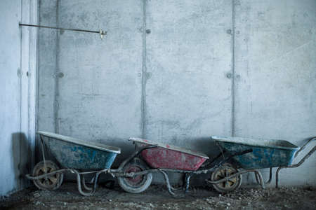 Row of three wheelbarrows on construction siteの写真素材