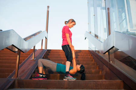 Two women training on stairway