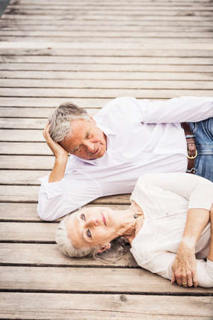Senior couple relaxing on pierの写真素材