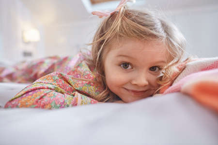 Girl lying on bedの写真素材