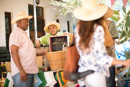 Market trader enticing tourist with signageの写真素材