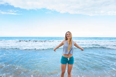 Portrait of young woman with arms open in sea, Dominican Republic, The Caribbeanの写真素材