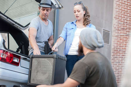 Musicians packing equipment into vehicleの写真素材