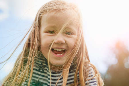 Portrait of girl looking at camera smilingの写真素材