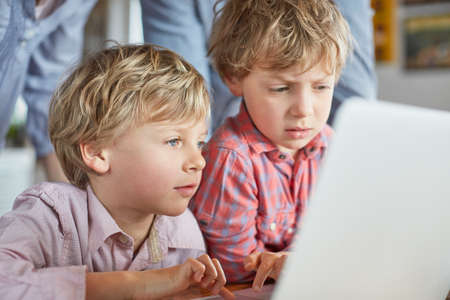 Boys using laptop