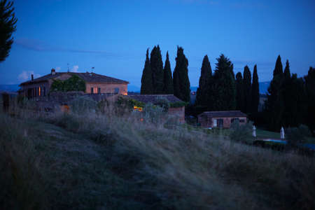 Row of houses on hillside, Buonconvento, Tuscany, Italyの写真素材