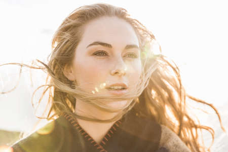 Woman enjoying breeze on sunny dayの写真素材