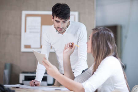 Young male and female designers having discussion in design studio